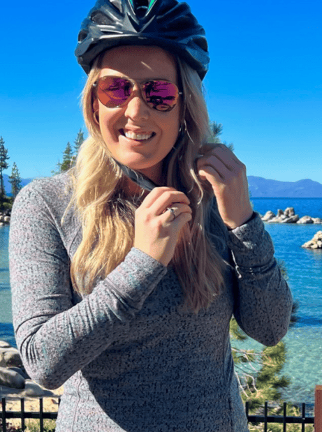 a woman buckling her bike helmet at lake tahoe